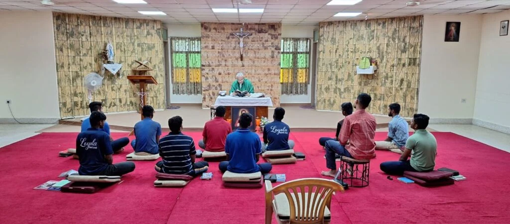 Retreatants seated in prayer before the chapel altar.