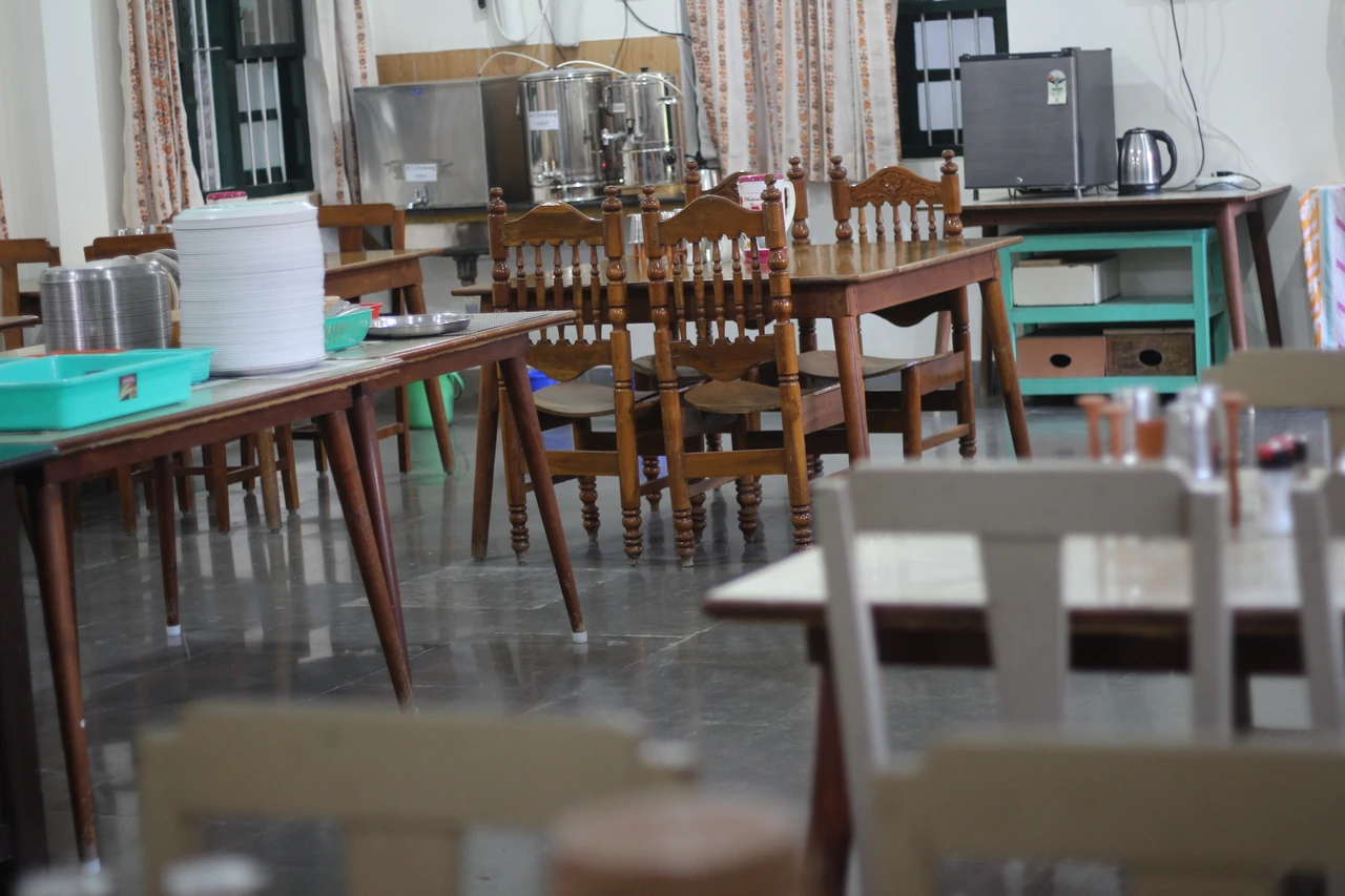 Tables, chairs and serving facilities inside the dining hall.